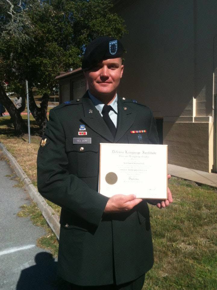 Matt Nelson in U.S. Army dress uniform holding his Defense Language Institute Mandarin Chinese diploma