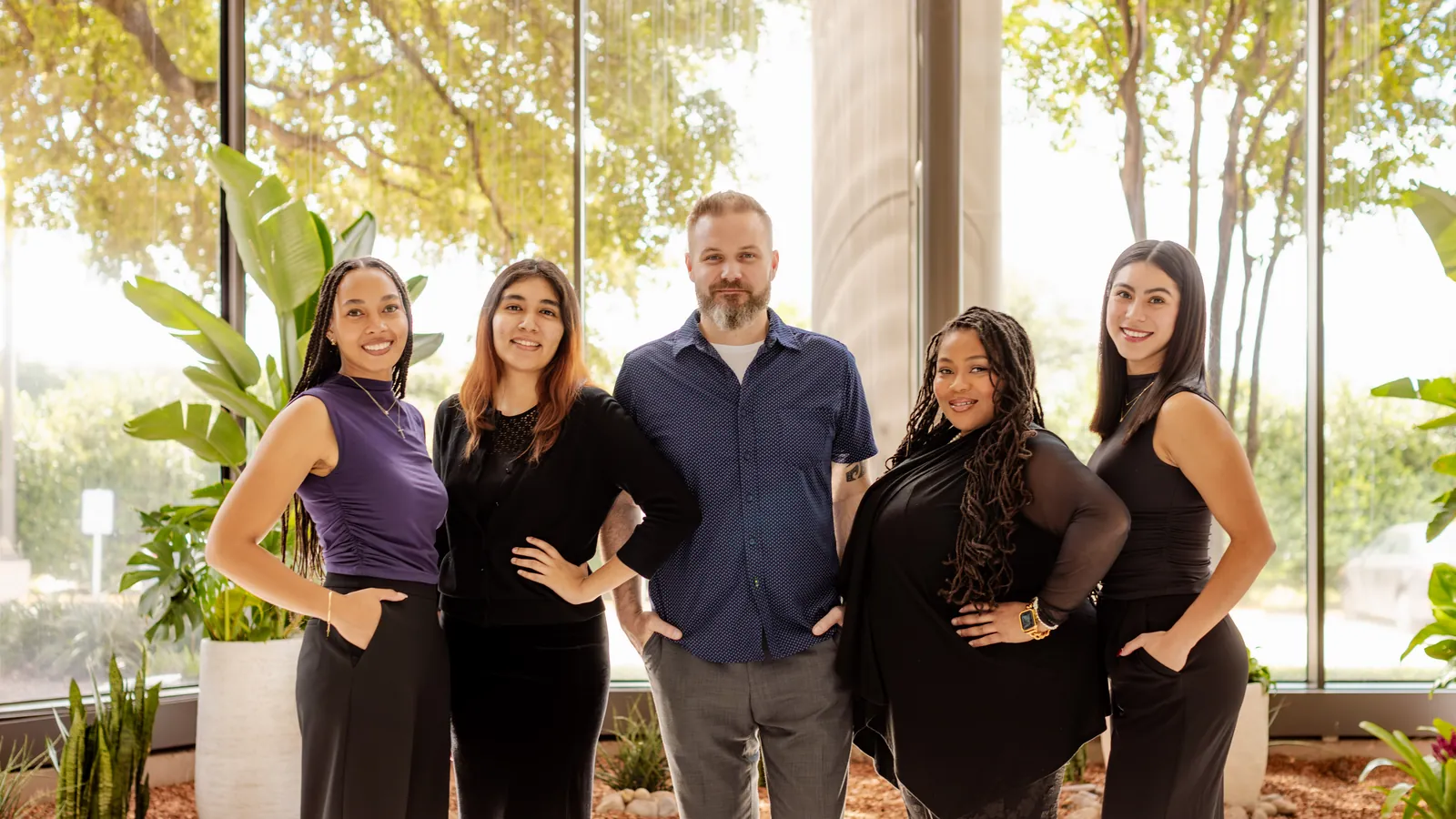 The Peachtree Rose Marketing team standing together in a sunlit lobby in San Antonio, Texas.
